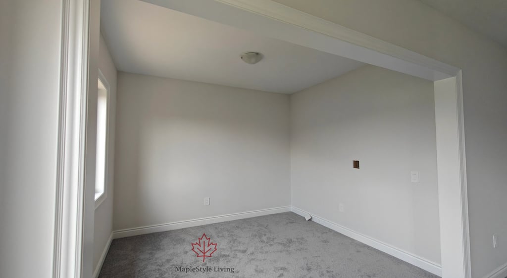 A standard spare room with carpet and plain walls before a luxury closet renovation by Maplestyle Li