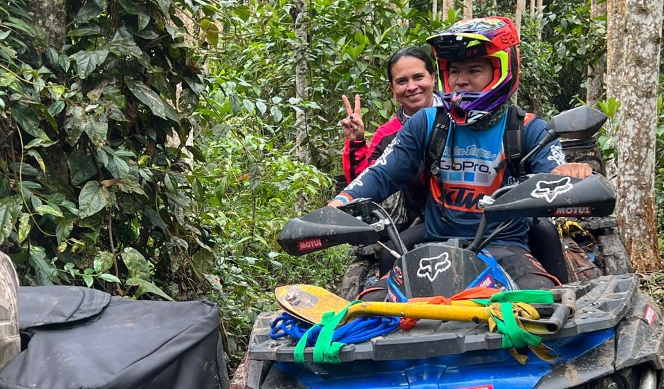 a man and woman riding on a four wheeler atv