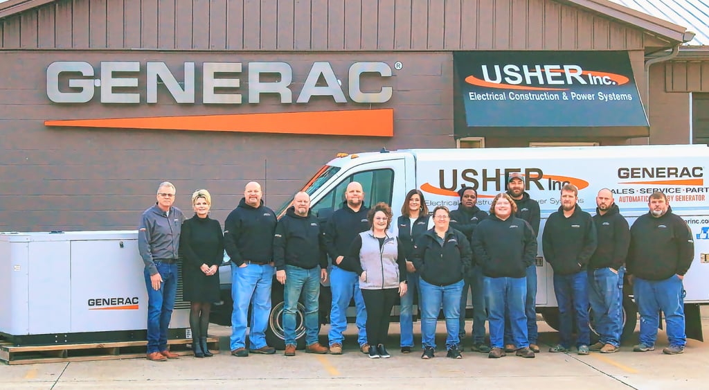 Usher's Ownwers and staff in front of there trucks and building