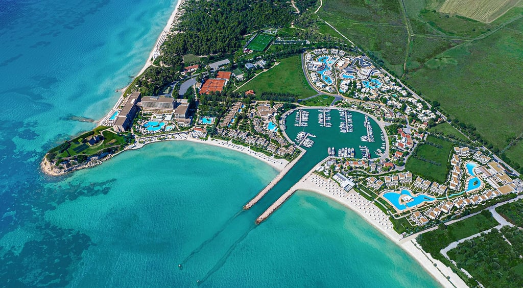 Sani resort luxury beachfront with marina with turquoise water and sandy beaches.