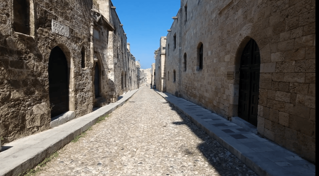 a narrow cobblestone street with a stone path in streets of knights in rhodes old town