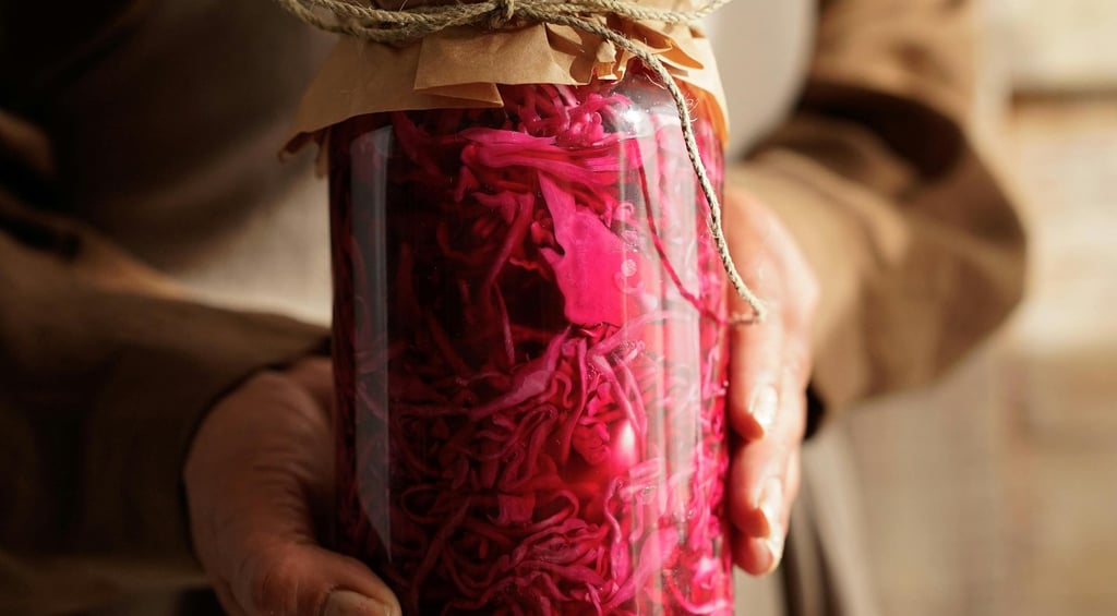 a woman holding a jar of red cabbage sauerkraut