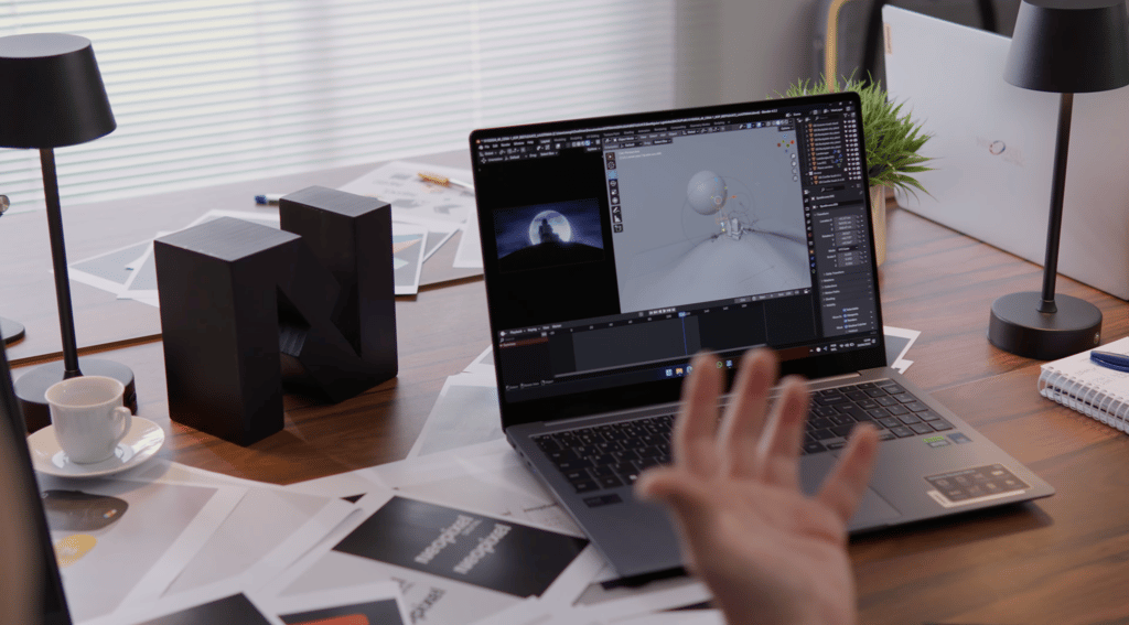 A person sitting at a desk with a laptop computer showing 3D animation software - Neopixel Digital