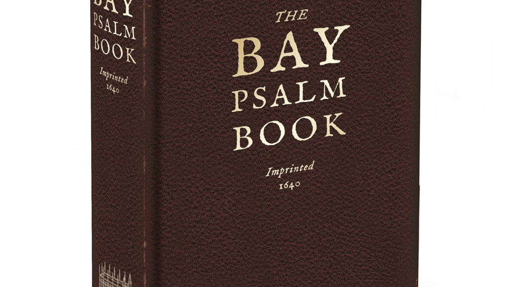 A hardcover edition of The Bay Psalm Book with a dark brown textured cover 