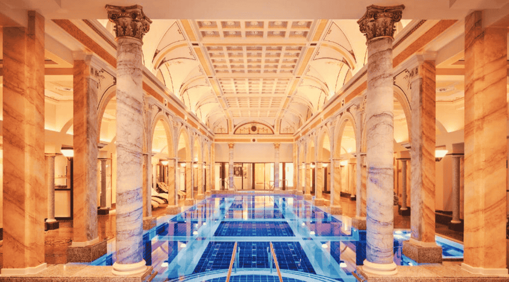wellness hotel with a large indoor swimming pool with a blue tiled floor