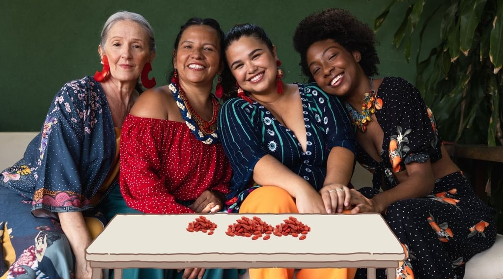 a group of women sitting on a couch with goji berries in front of them on table