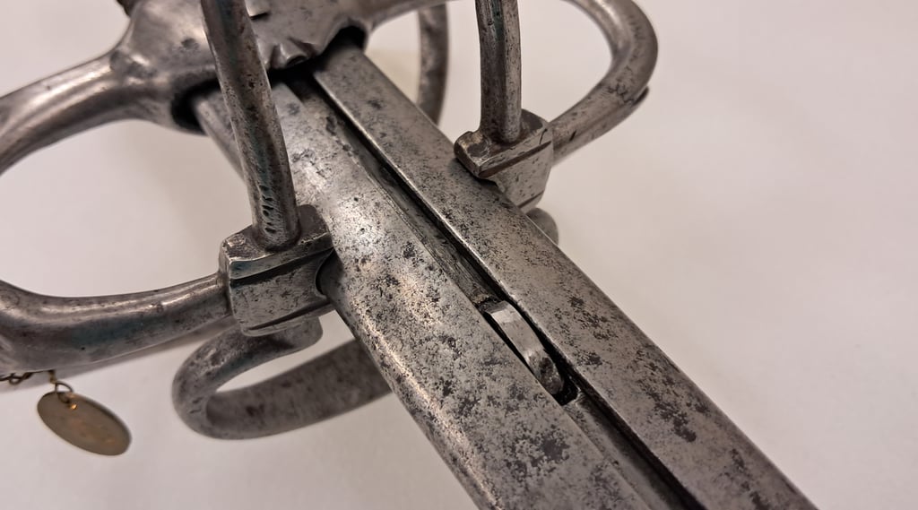 Detail of the grooved metal sleeve and locking latch on the extending rapier.