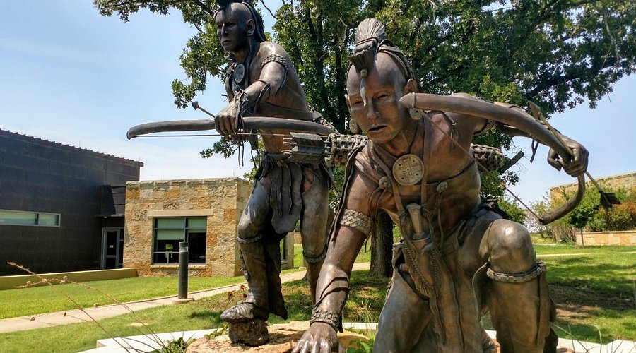 a statue of a man and a woman with bow