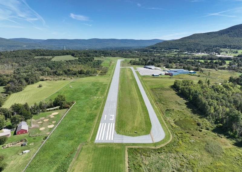 Aerial view of William H. Morse State Airport in Bennington, VT surrounded by fields and mountains.