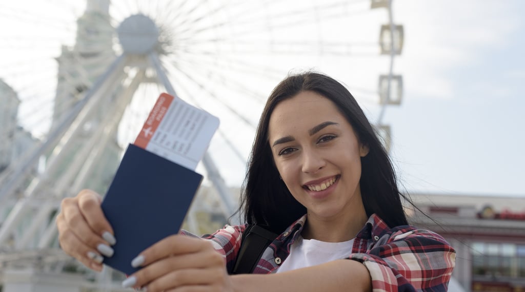 Woman holding passport and boarding pass, representing readiness for international education & visa