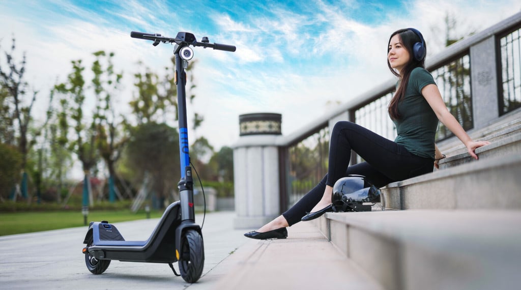 a woman sitting on a ledge with a scooter