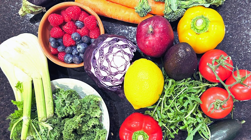 Variety of vegetables and fruits e.g. berries, kale, tomatoes, carrots, peppers, broccoli, lemon