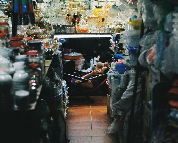 Market vendor relaxing in Saigon