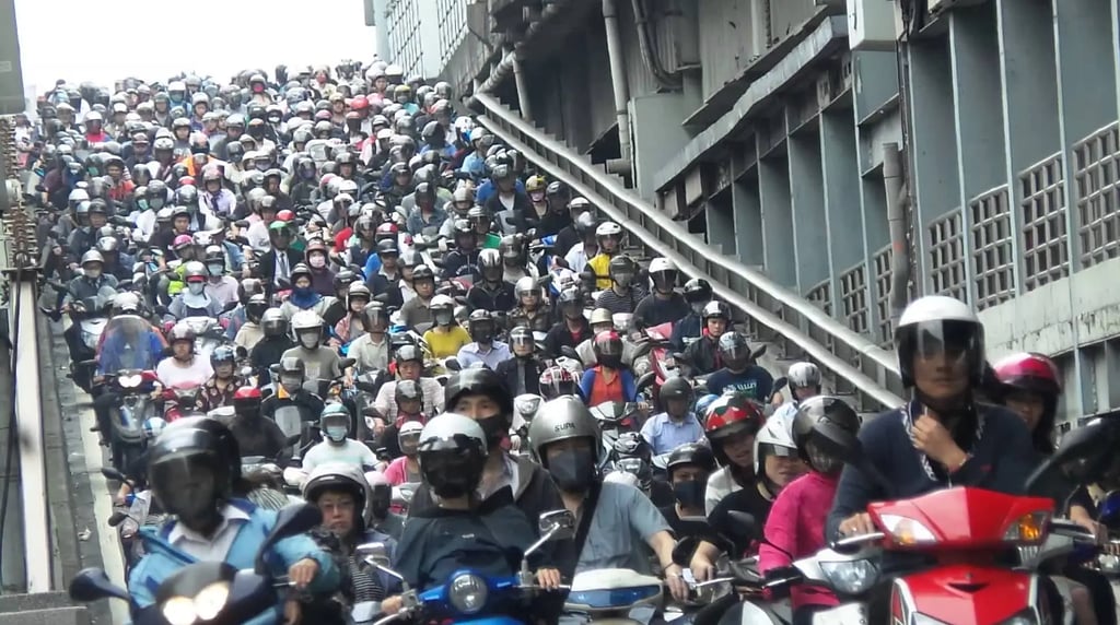 a large group of people riding on motorbikes