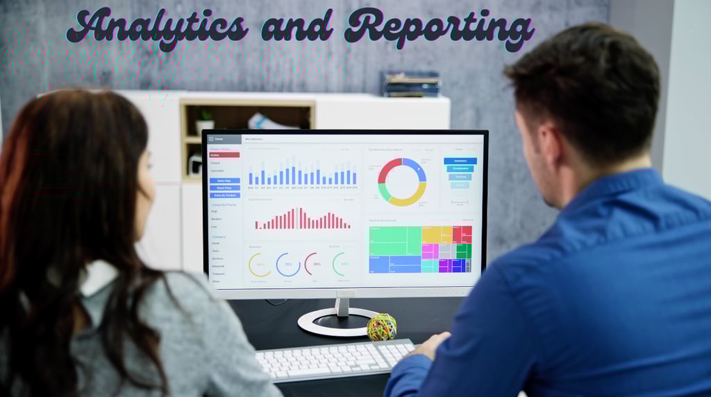 a man and woman sitting at a desk with a computer monitor analytics and reporting on the screen