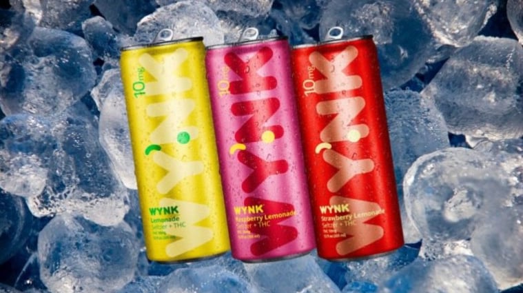 three cans of pink lemonade on ice