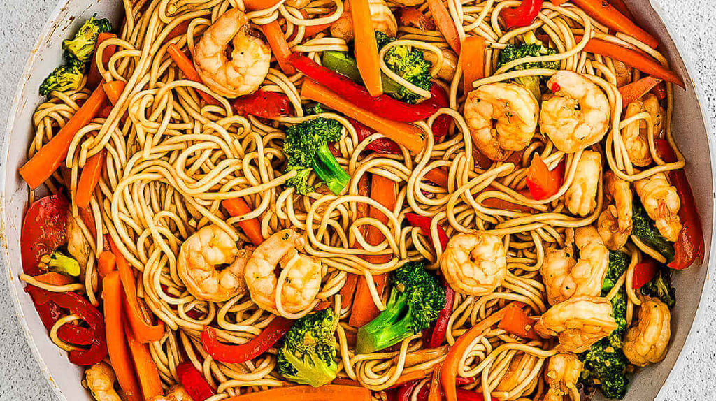 a bowl of noodles with shrimp and vegetables lo mein