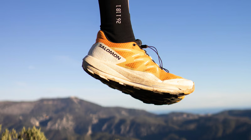 a person's feet in the air with a pair of socks on