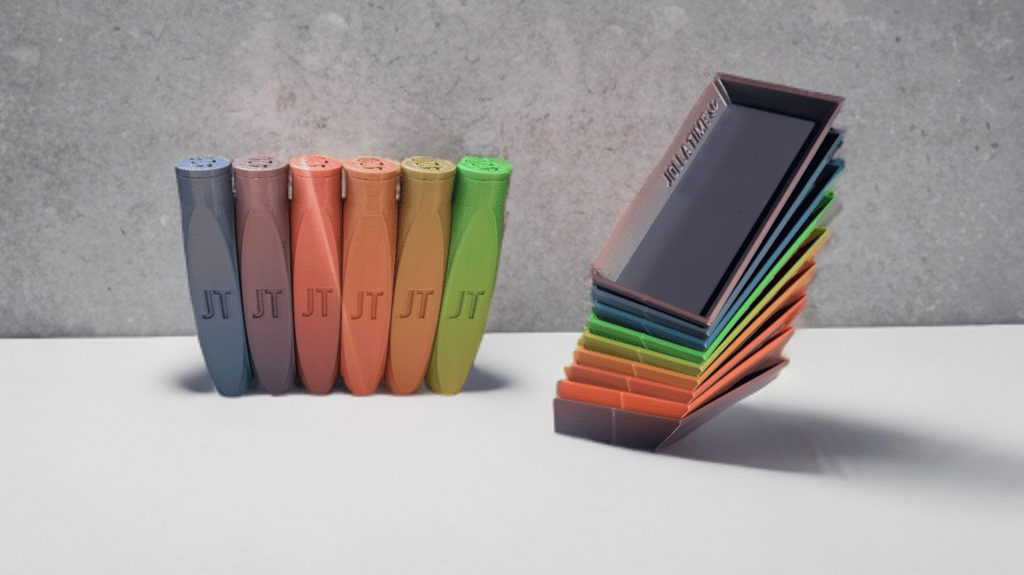Colorful 3D printed organizing containers and stacked lids with JT logo branding.