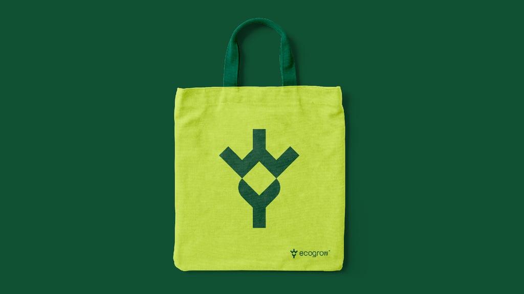 Green tote bag design with geometric leaf logo.