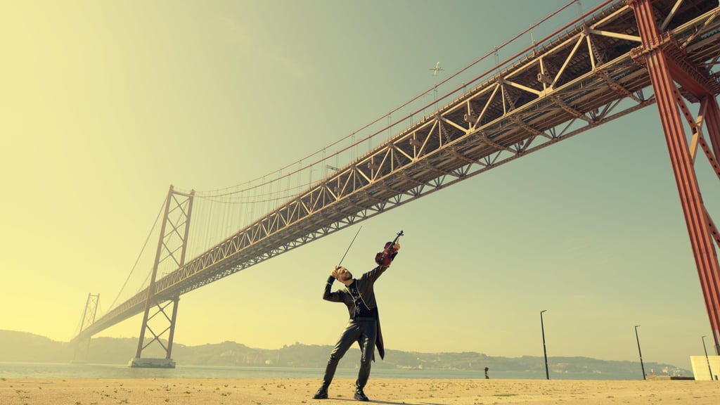 a man is flying a kite in the sand
