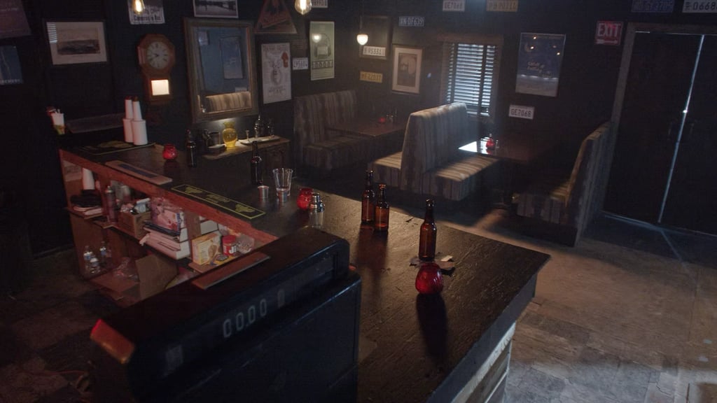 Bar room set at Grayfox Studios with counter, bottles, booths, and vintage wall decor