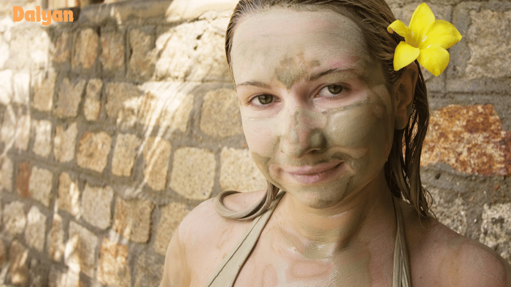 Mud bathing woman with a flower in her hair
