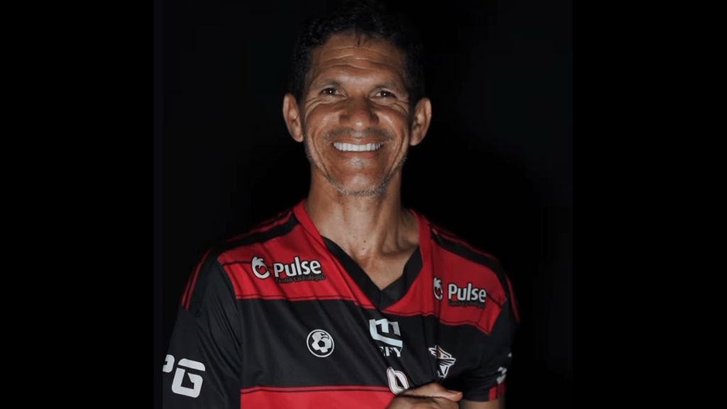 a man in a red and black shirt smiling