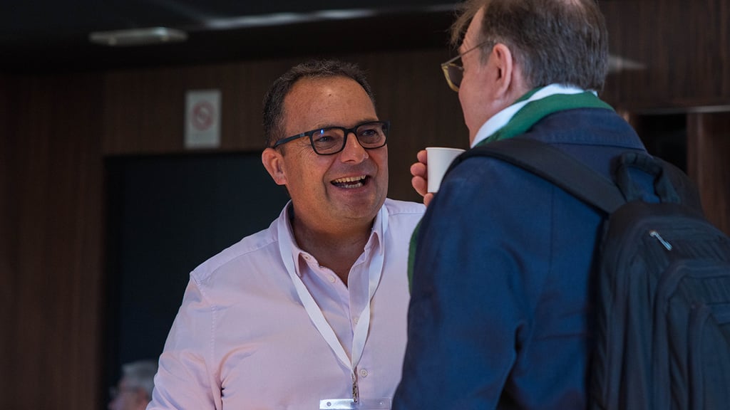 a man in a pink shirt and a man in a blue jacket