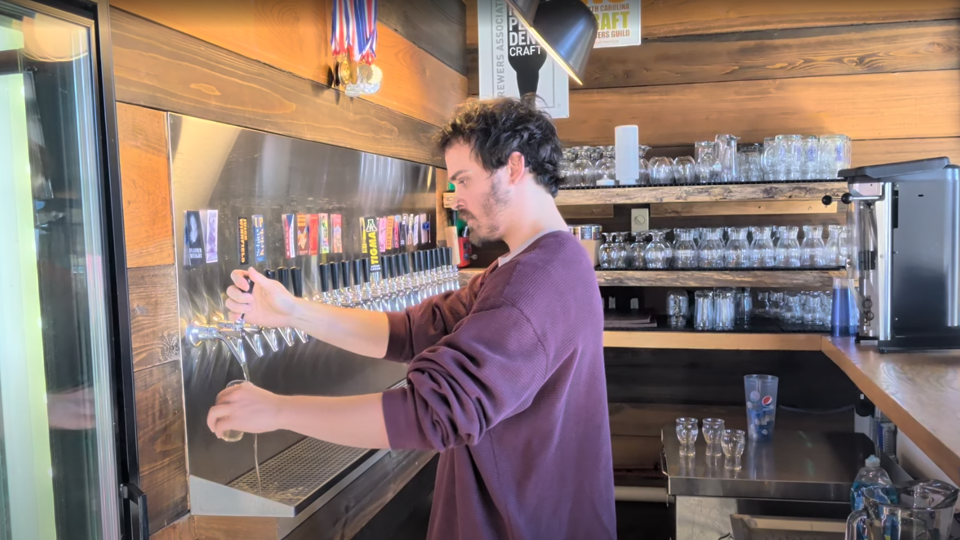 Hunter of Lost Province Brewing tapping a pint of beer