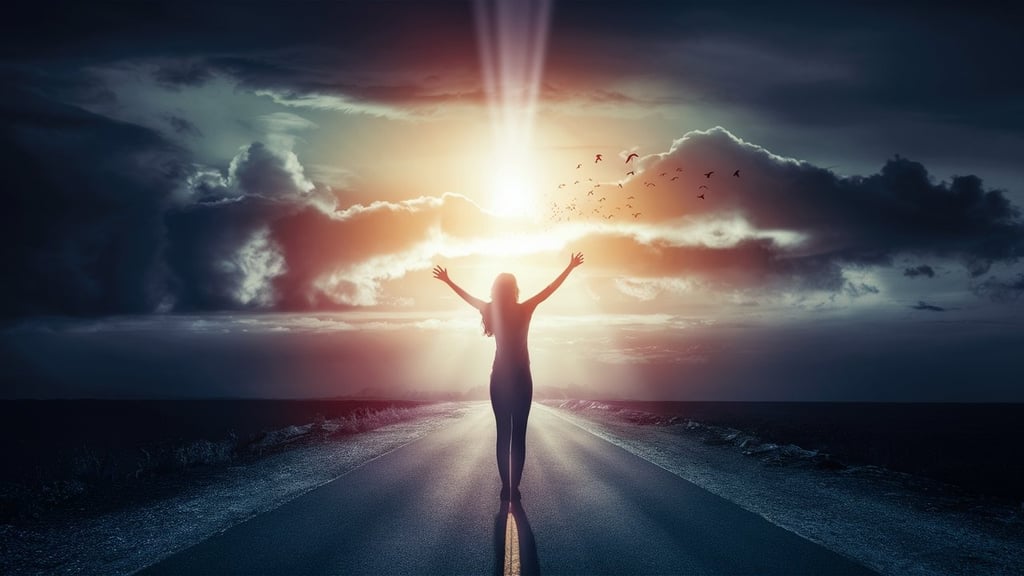 a young woman standing on a road with their arms up in the air
