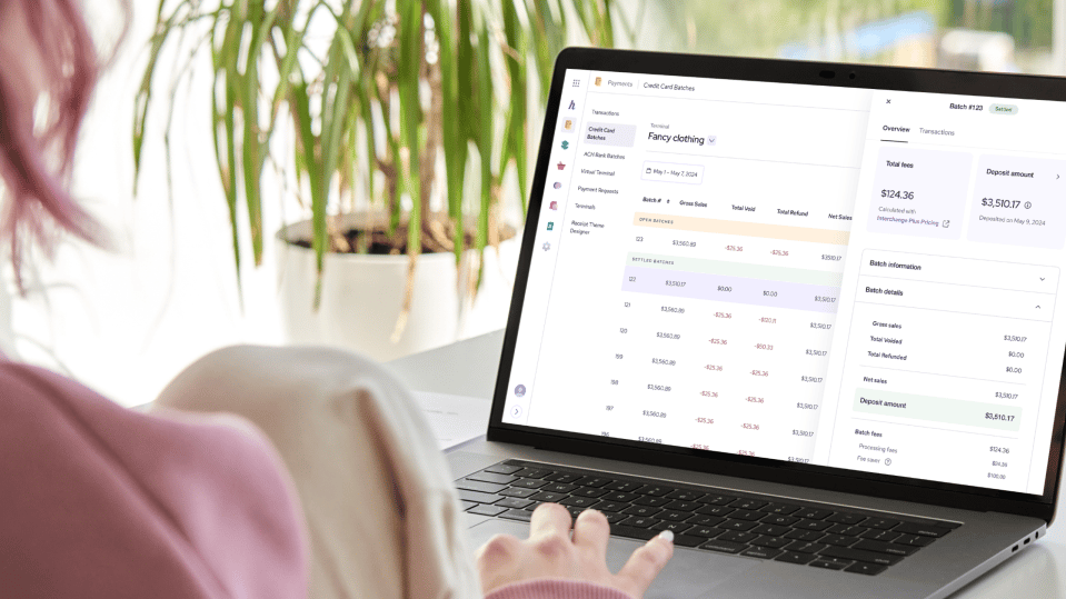 Business owner comparing payment processor options on a laptop
