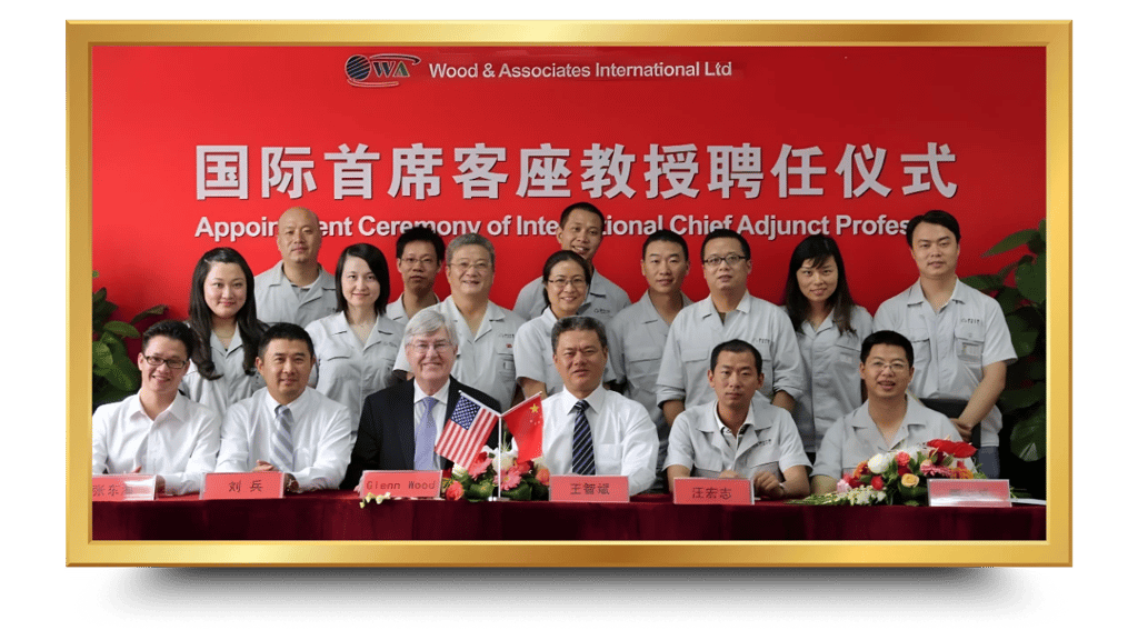 a group of people standing around a table with a flag