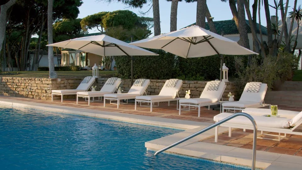 Sun loungers by the main pool at Villa El Rincon