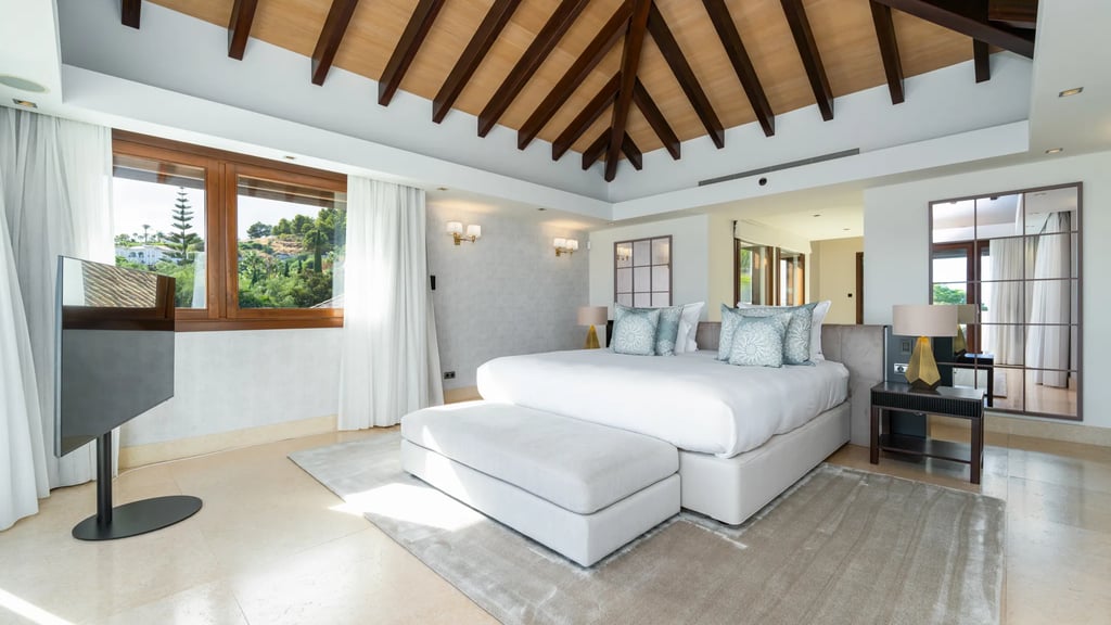 Master bedroom with vaulted ceiling and hillside views