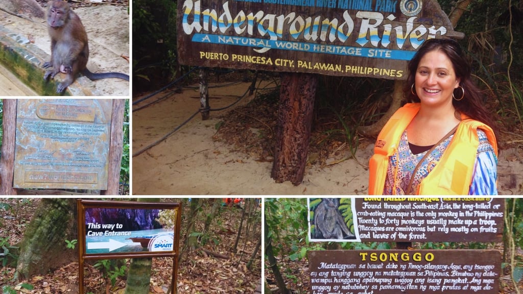 Autora na entrada do rio subterrâneo com placa indicativa e macaco ao fundo.