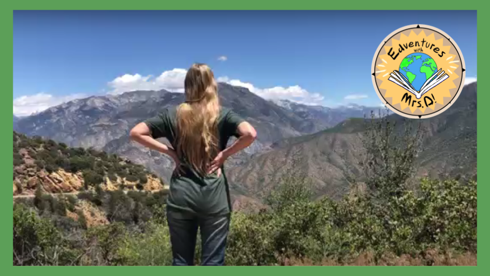 a teacher standing on a mountain top overlooking the valley below