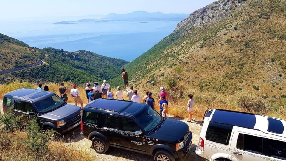 a group of people standing on a hill top