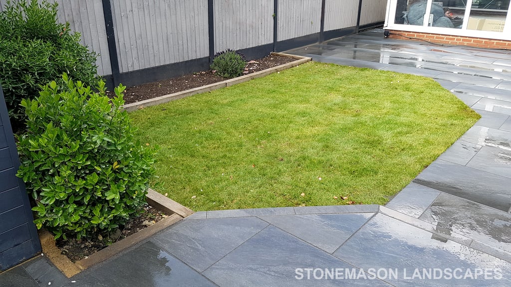 Grey sandstone circle paving slabs with charcoal edging