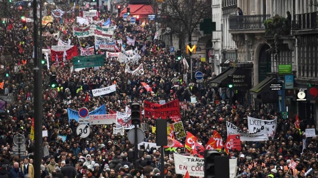 a large group of people walking down a street