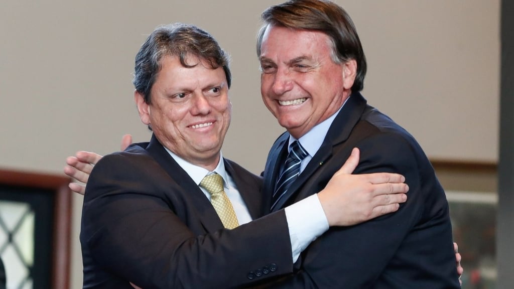 two men in suits and ties are hugging each other