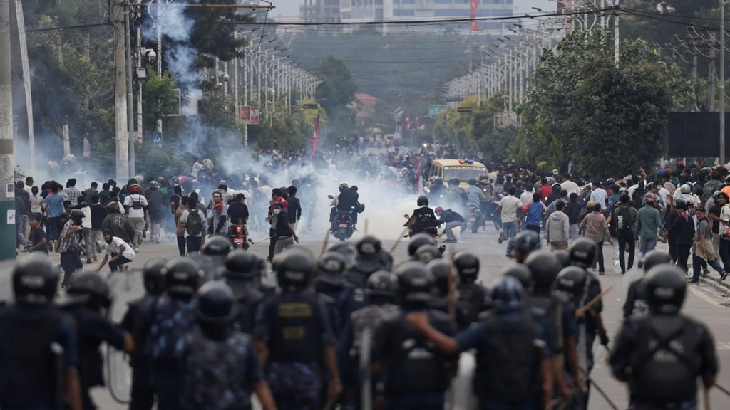 a group of people standing in front of a group of police officers