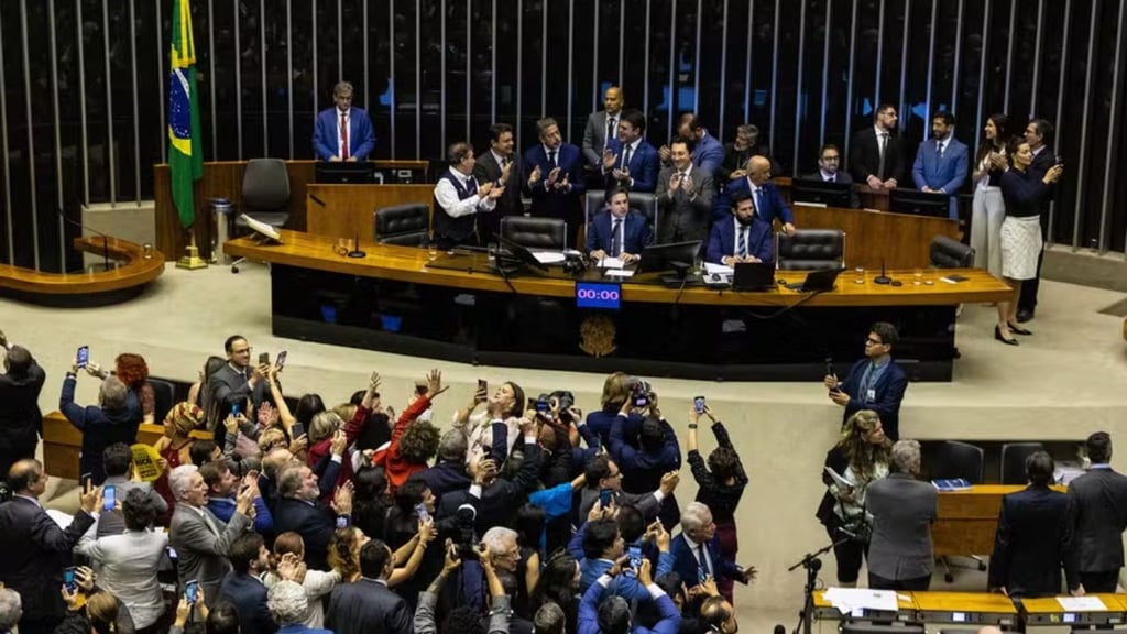 a large group of people standing around a table