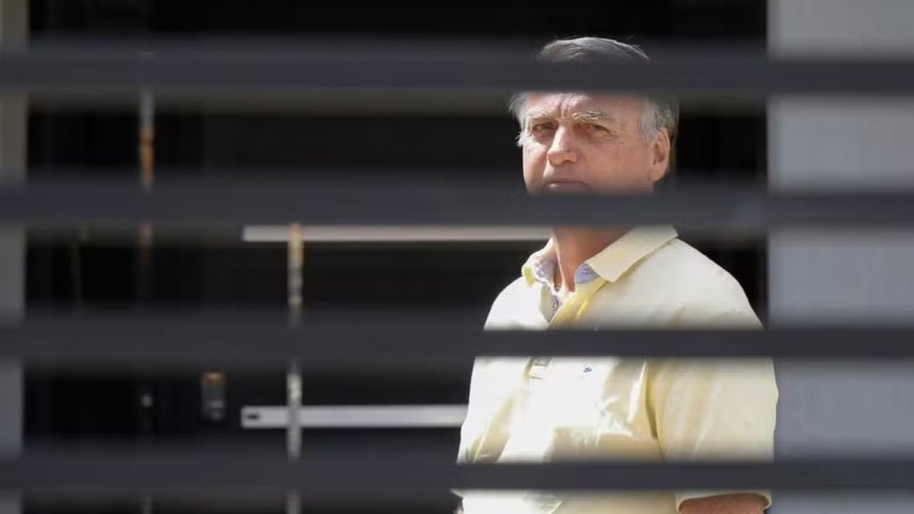 a man in a yellow shirt and tie dyes a tie