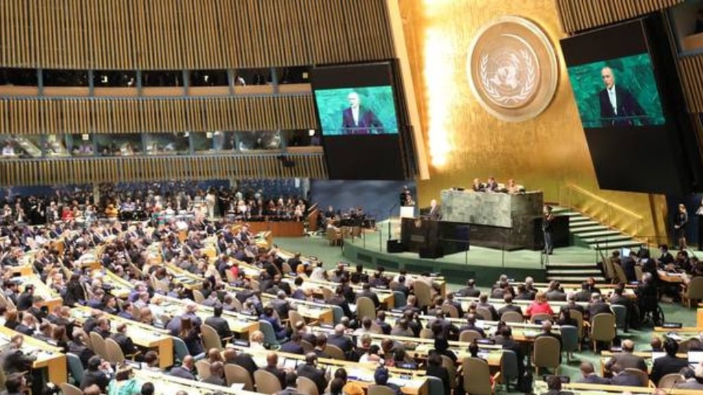 a large group of people sitting in a large room