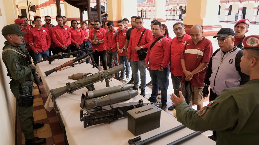 a man in a red jacket is standing in front of a table with a bunch