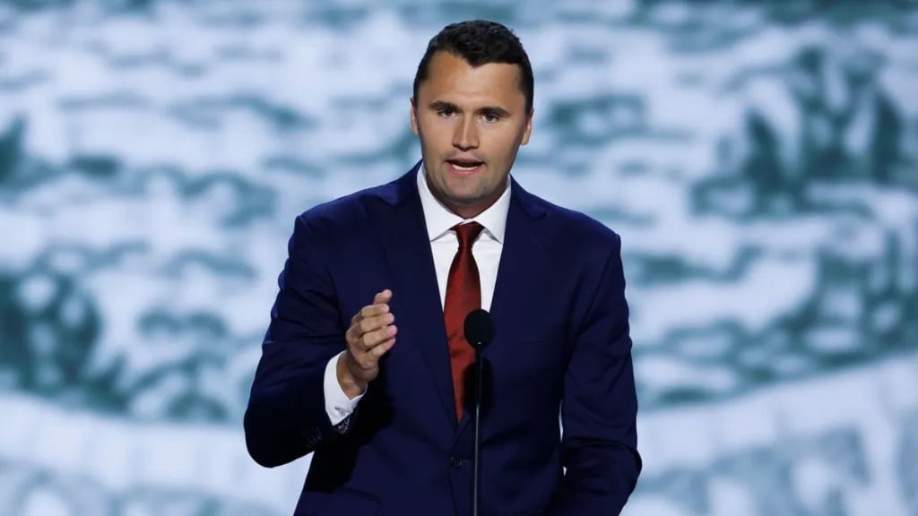 a man in a suit and tie is giving a speech
