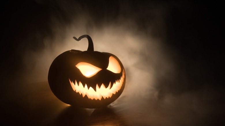 Jack o lantern at night in fog