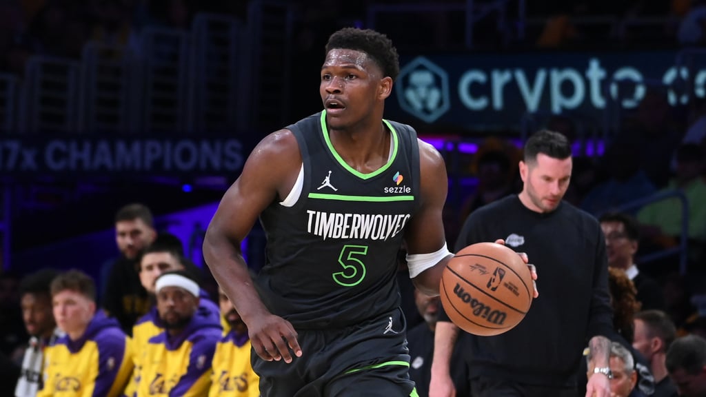 a man in a black jersey and a basketball ball