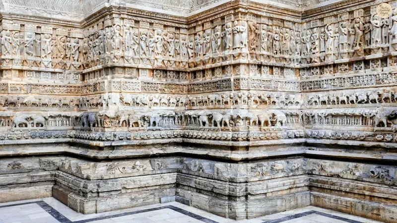 Intricate stone carvings at Jagdish Temple in Udaipur, showing detailed figures and mythological motifs.